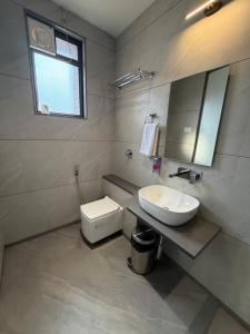 a bathroom with a sink and a toilet and a mirror at O'Nest Select in Peth +26 photos