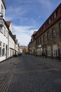 an empty cobblestone street in a town with buildings at Ludwig9 in Bayreuth
