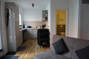 a living room with a couch and a kitchen at Ludwig9 in Bayreuth