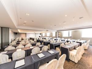 a large room with tables and white chairs at Mercure Xian City Centre in Xi'an