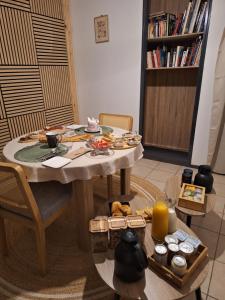 a table with food on it in a living room at Détente Gersoise in Lasserade