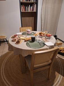 a table with a plate of food on it at Détente Gersoise in Lasserade