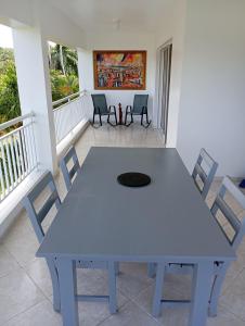 a white table and chairs on a balcony at Caoba in Las Terrenas