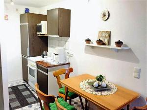 una pequeña cocina con mesa de madera y sillas en Ferienwohnung Sievers, en Barlt