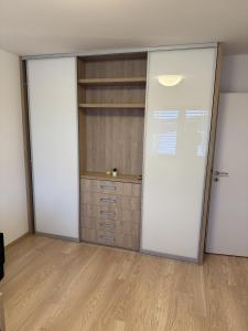 an empty room with two sliding doors and a closet at Vila 512 priamo pri jazere in Šajdíkove Humence