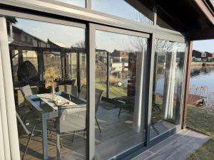 a screened in porch with a table and chairs at Vila 512 priamo pri jazere in Šajdíkove Humence