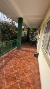 a balcony of a house with a red tile floor at GreenHouse in Brca