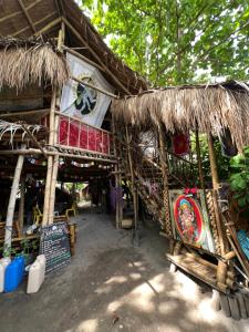 a building with a straw hut with a sign on it at Tribal Huts Community in Malapascua Island
