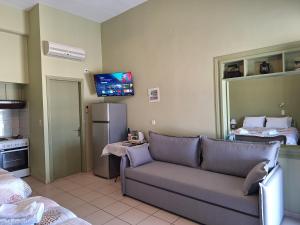 a living room with a couch and a refrigerator at Myrto in Tyros