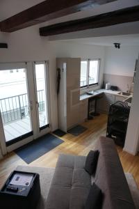 a living room with a couch and a kitchen at Ludwig9 in Bayreuth