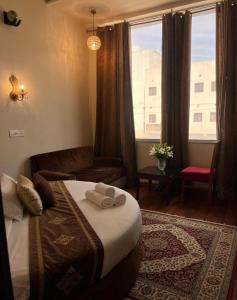 a bedroom with a bed and a couch and a window at Hotel WoodCresstt Zirakpur !! Budget Friendly Stay With Airport Access in Zirakpur