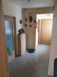 a hallway of a house with a door and a tile floor at Appartment Annika in Hochheim