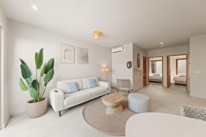 a living room with a couch and a table at NÔA Curacao in Willemstad +85 photos