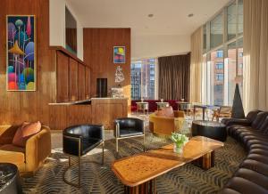 a living room with a couch and a table and chairs at ModernHaus SoHo in New York