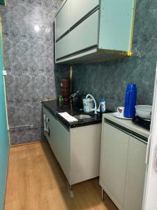 a kitchen with a sink and a counter top at Interlagos Family House in São Paulo