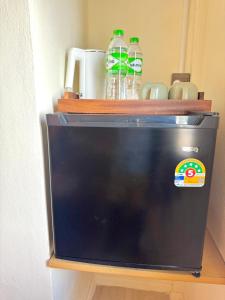 a bottle of water sitting on top of a microwave at Sunvada Beach Rayong in Rayong