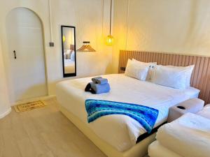 a bedroom with a large bed with a blue bag on it at Sunvada Beach Rayong in Rayong +120 photos