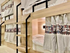 a bedroom with two bunk beds in a room at 12H Hostel in Al-ʿUla