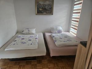 two twin beds in a room with a window at Forest Haven in Unterkirnach
