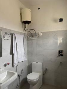 a bathroom with a white toilet and a sink at Dod gu Yongs Khil in Karu +5 photos
