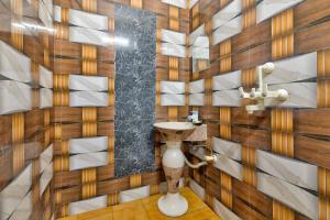 a bathroom with a sink and wooden walls at Hotel Brij Stone in Vrindāvan