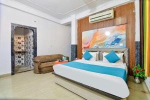 a bedroom with a large bed and a couch at Hotel Brij Stone in Vrindāvan