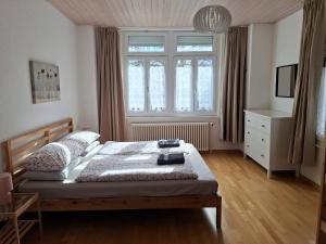 a bedroom with a bed and a large window at Interlaken Central 1 in Interlaken