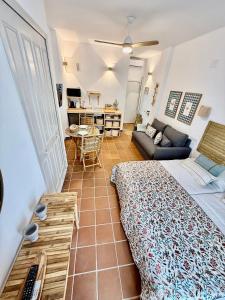 a bedroom with a bed and a living room at Suite Triana in El Rocío