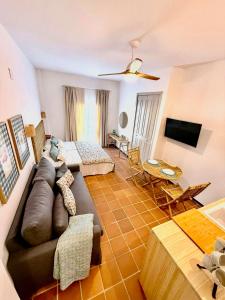 a living room with a couch and a tv at Suite Triana in El Rocío