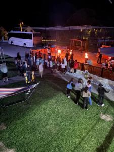a group of people standing in a field at night at Pensiunea Casa David in Şugag +49 photos