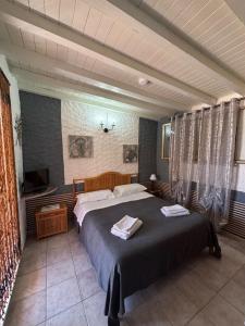 a bedroom with a large bed and a television at Residence Il Melograno in Lampedusa