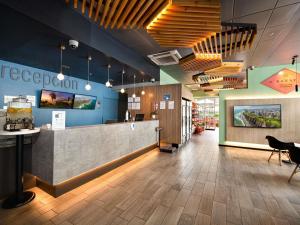 a lobby of a restaurant with a counter and chairs at ibis budget Lima Miraflores in Lima
