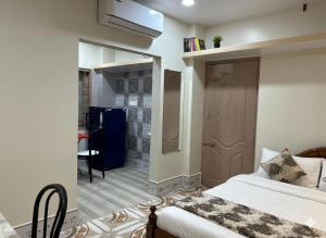 a bedroom with a bed with a mirror and a bathroom at Veda Home's B in Agartala