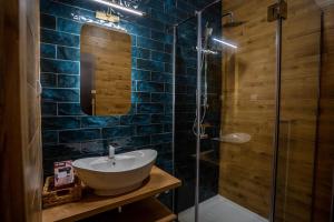 a bathroom with a sink and a glass shower at Apartment Jungle in Belgrade