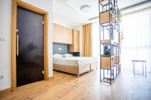 a bedroom with a bed and a ladder next to a door at Apartment Jungle in Belgrade