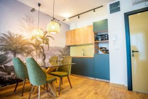 a kitchen and dining room with a table and chairs at Apartment Jungle in Belgrade