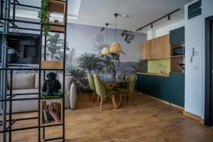 a kitchen and dining room with a table and chairs at Apartment Jungle in Belgrade