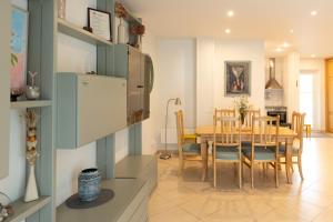 a kitchen and dining room with a table and chairs at AV villa in Nida