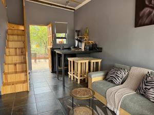 a living room with a couch and a table at Boskoors in Hammanskraal +41 photos