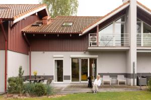 two people sitting on the porch of a house at AV villa in Nida