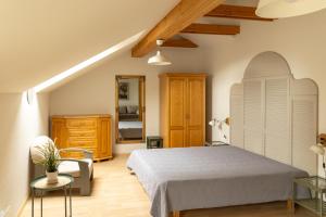 a bedroom with a bed and a dresser at AV villa in Nida