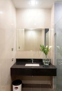 a bathroom with a sink and a vase with a plant at Satun Le Grand - โรงแรม สตูล เลอแกรนด์ in Ban To La Nua +19 photos