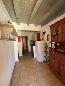 a kitchen with white appliances and a tile floor at Residence Il Melograno in Lampedusa