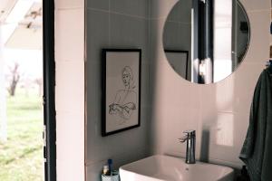 a bathroom with a sink and a mirror at Nomad Yurt, 60 year old in Ryskulovo