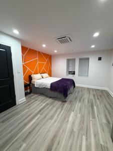 a bedroom with a bed and a wooden floor at Cozy Modern Studio in Philadelphia