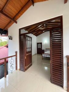 an open room with a bed in a bedroom at Mayon's Home in Kalutara +18 photos
