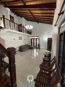 a large living room with chairs and a couch at Mayon's Home in Kalutara