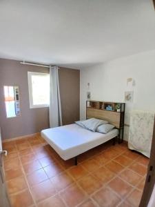 a bedroom with a white bed and two windows at Maison dans village de vacances 5 pers climatisé piscine in Gaujac +13 photos