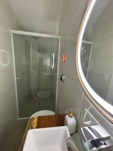 a bathroom with a sink and a mirror at Kitnet bem equipada para 2 pessoas in Curitiba +19 photos