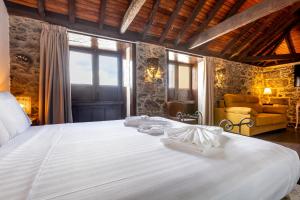 a bedroom with a large white bed in a room at Hotel Emblemático Duque de la Torre in Arona +140 photos